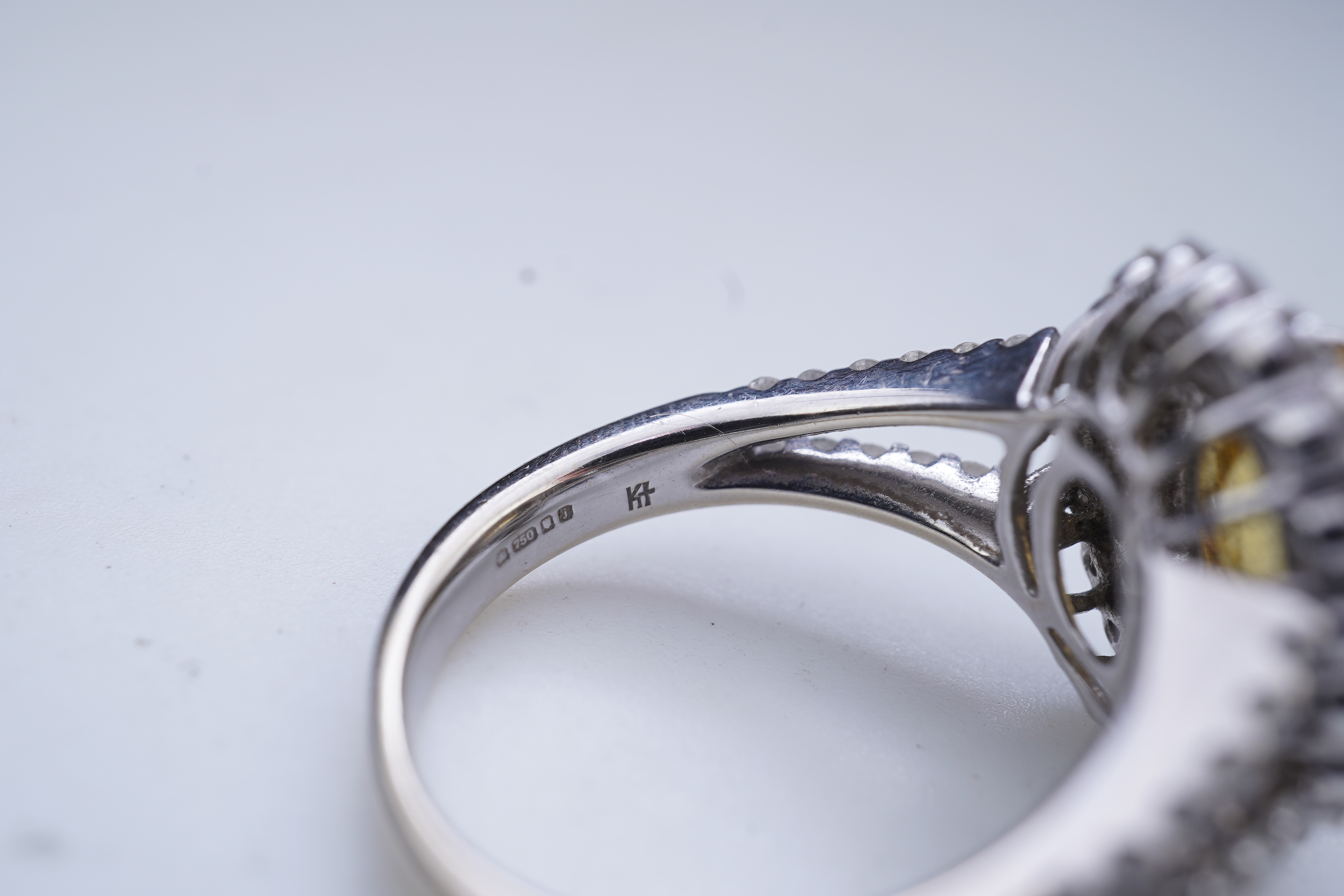 A yellow sapphire and diamond ring
